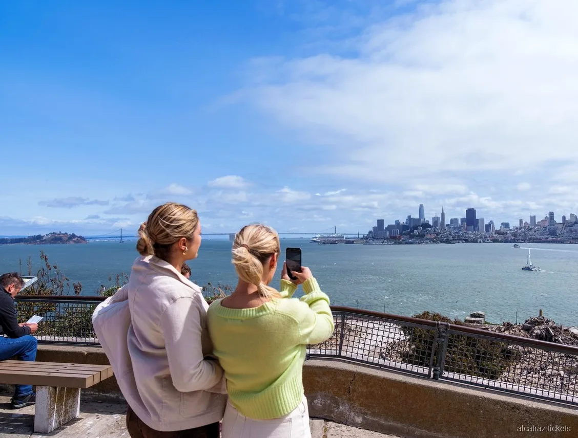 Visitors walking the Alcatraz Cellhouse Audio Tour inside the main prison building